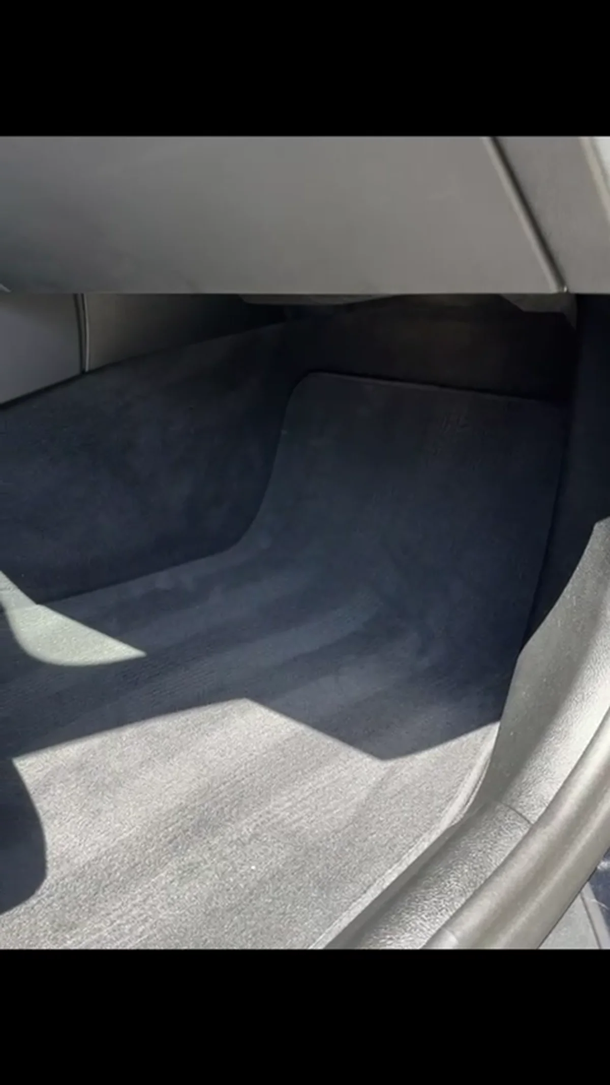 Clean dark BMW carpet after detailing