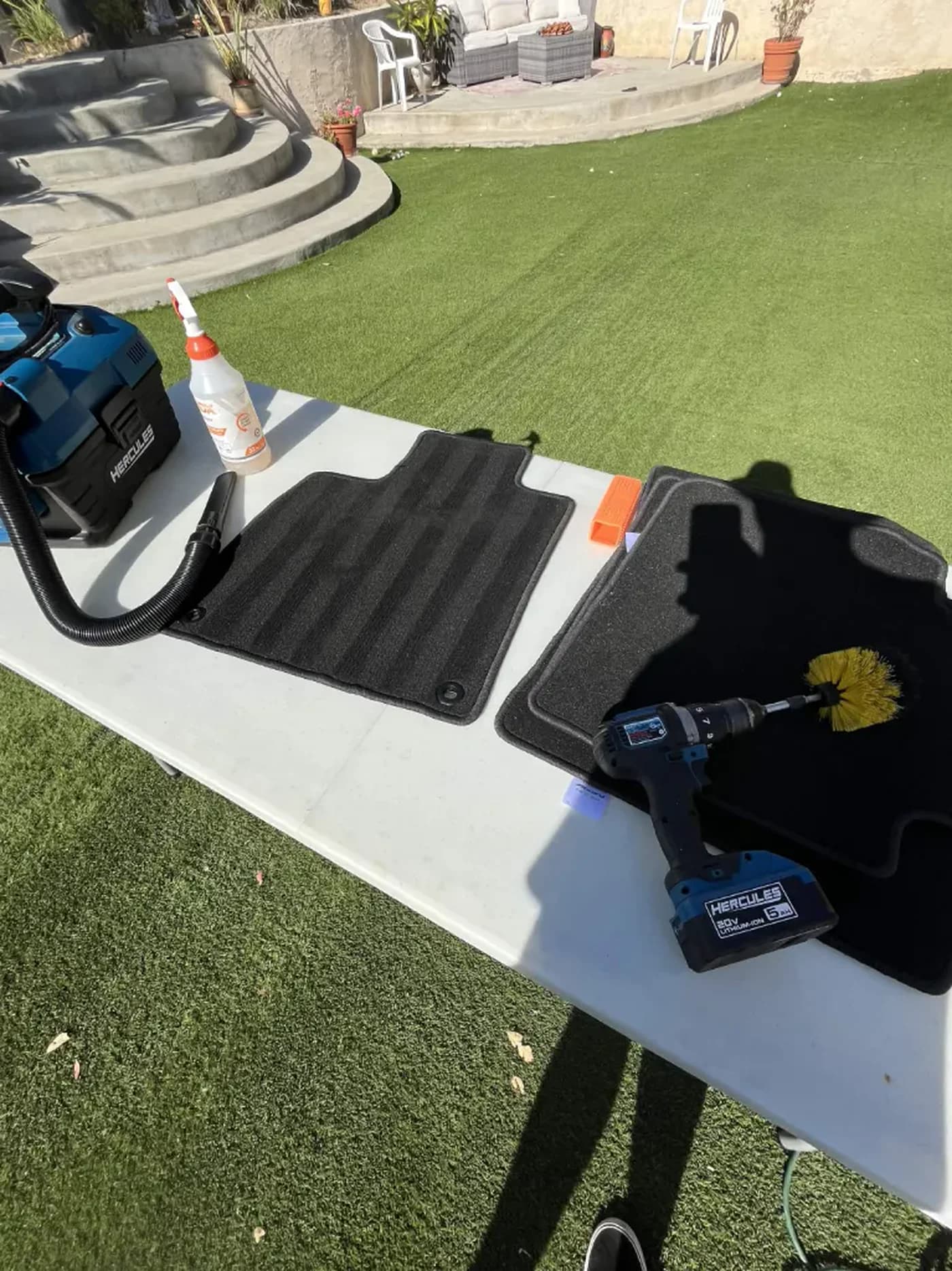 Floor mats and detailing tools arranged for cleaning