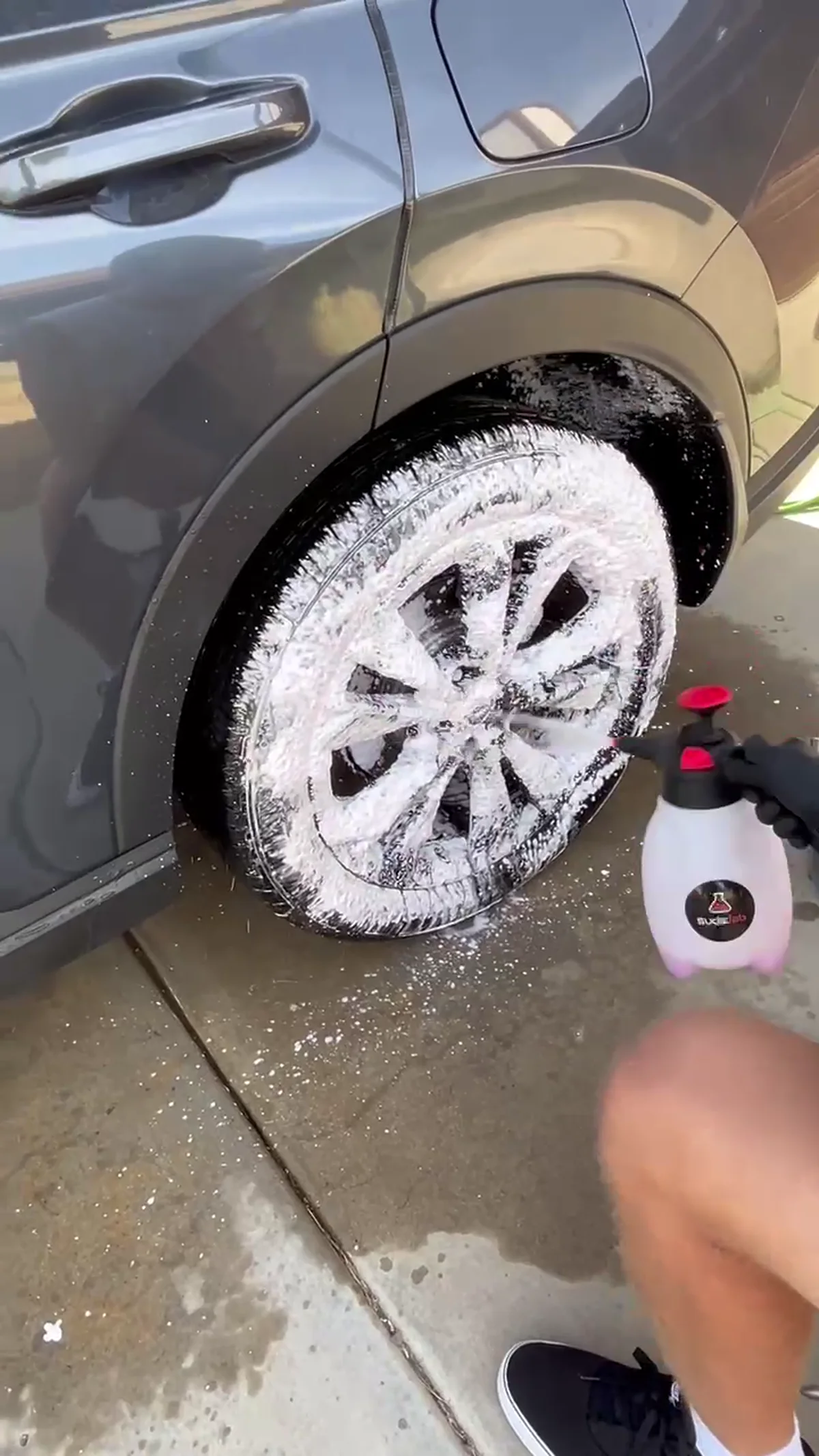 A&N detailer cleaning a wheel by hand