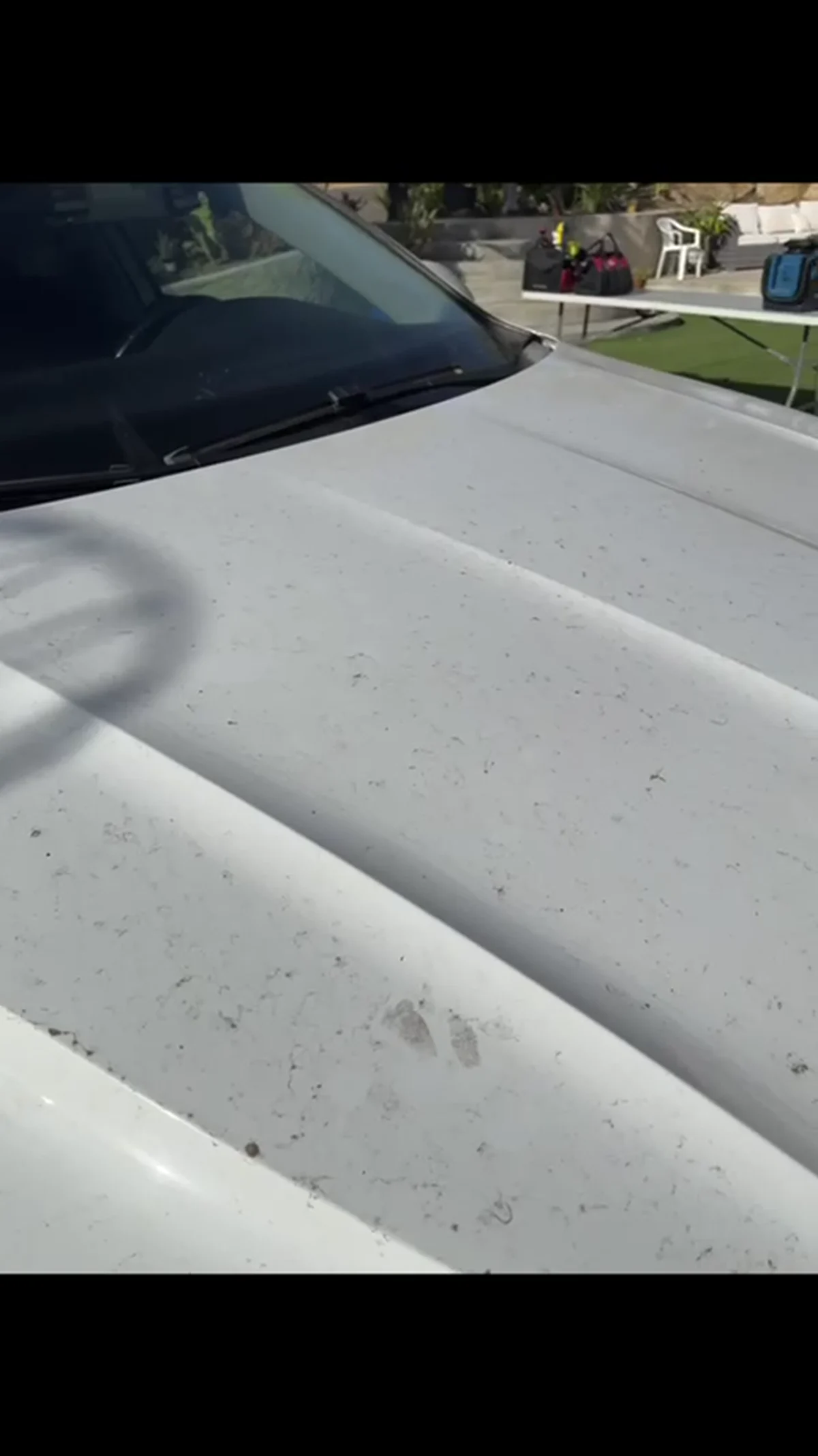 White Volkswagen hood before detailing with visible debris